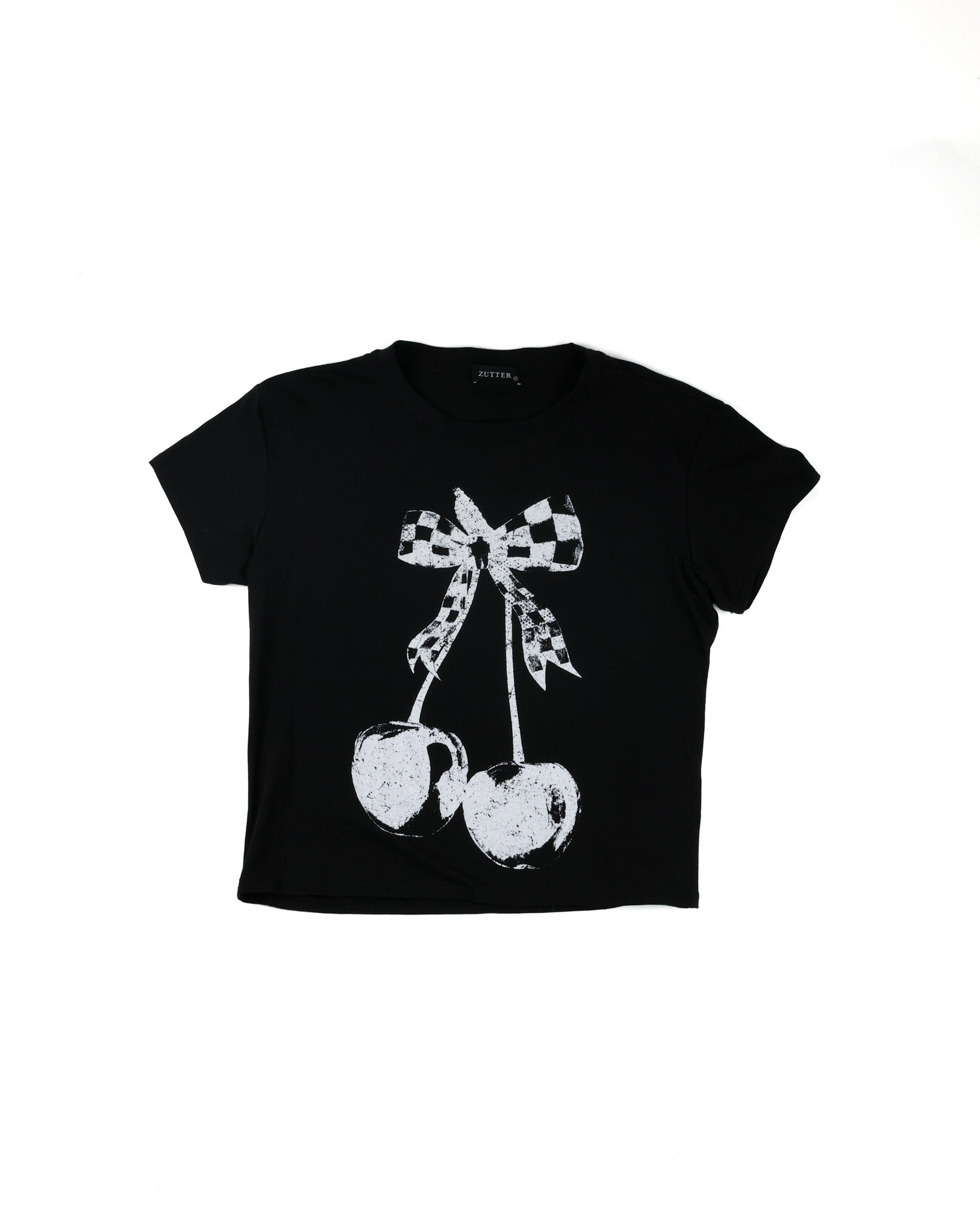A black short-sleeve crop top t-shirt featuring a distressed white graphic of two cherries tied with a black-and-white checkered bow, shown on a plain white background.