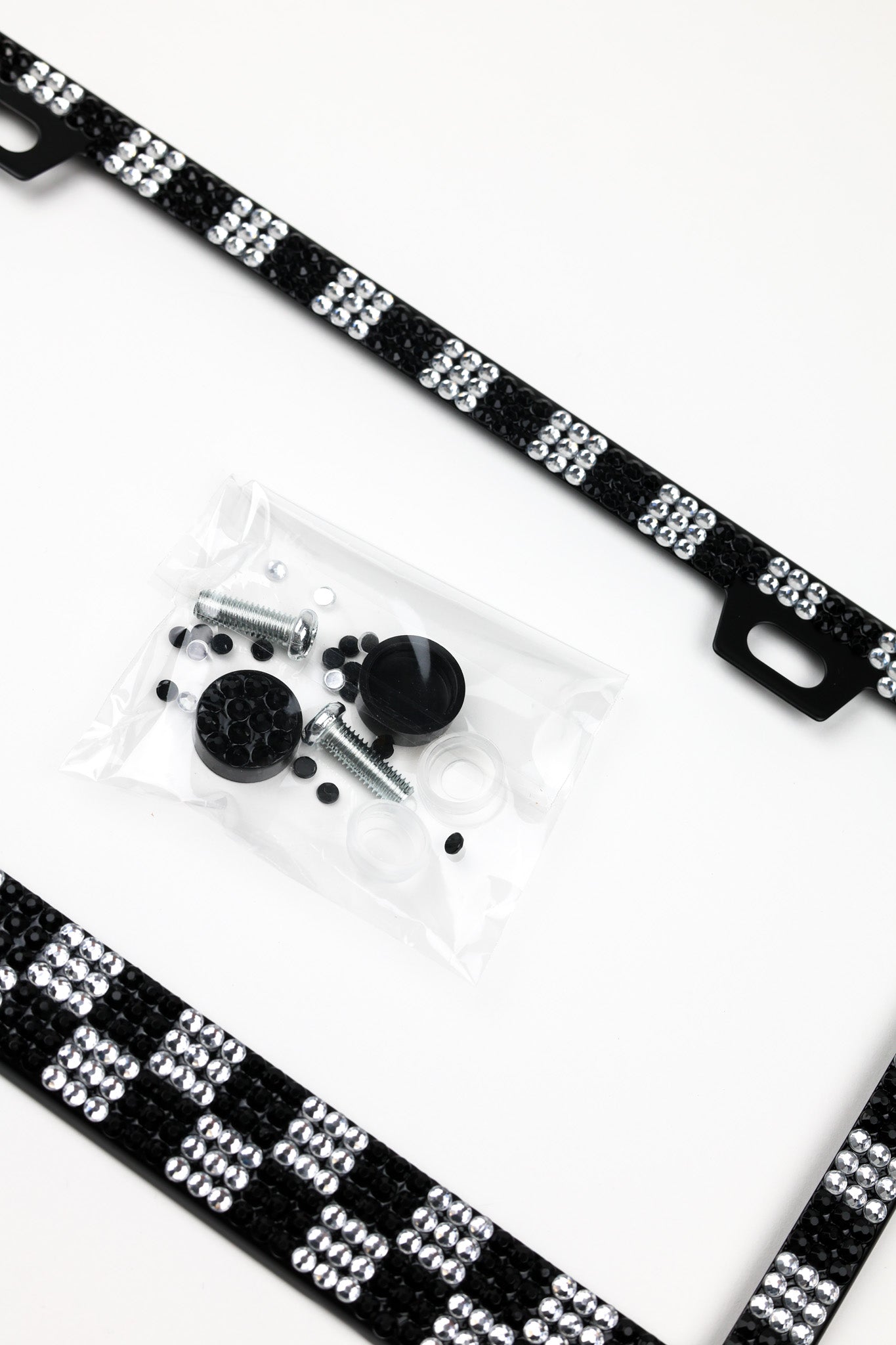 Black and white checkered beaded strap with mounting hardware in a clear plastic bag, displayed on a clean white background.