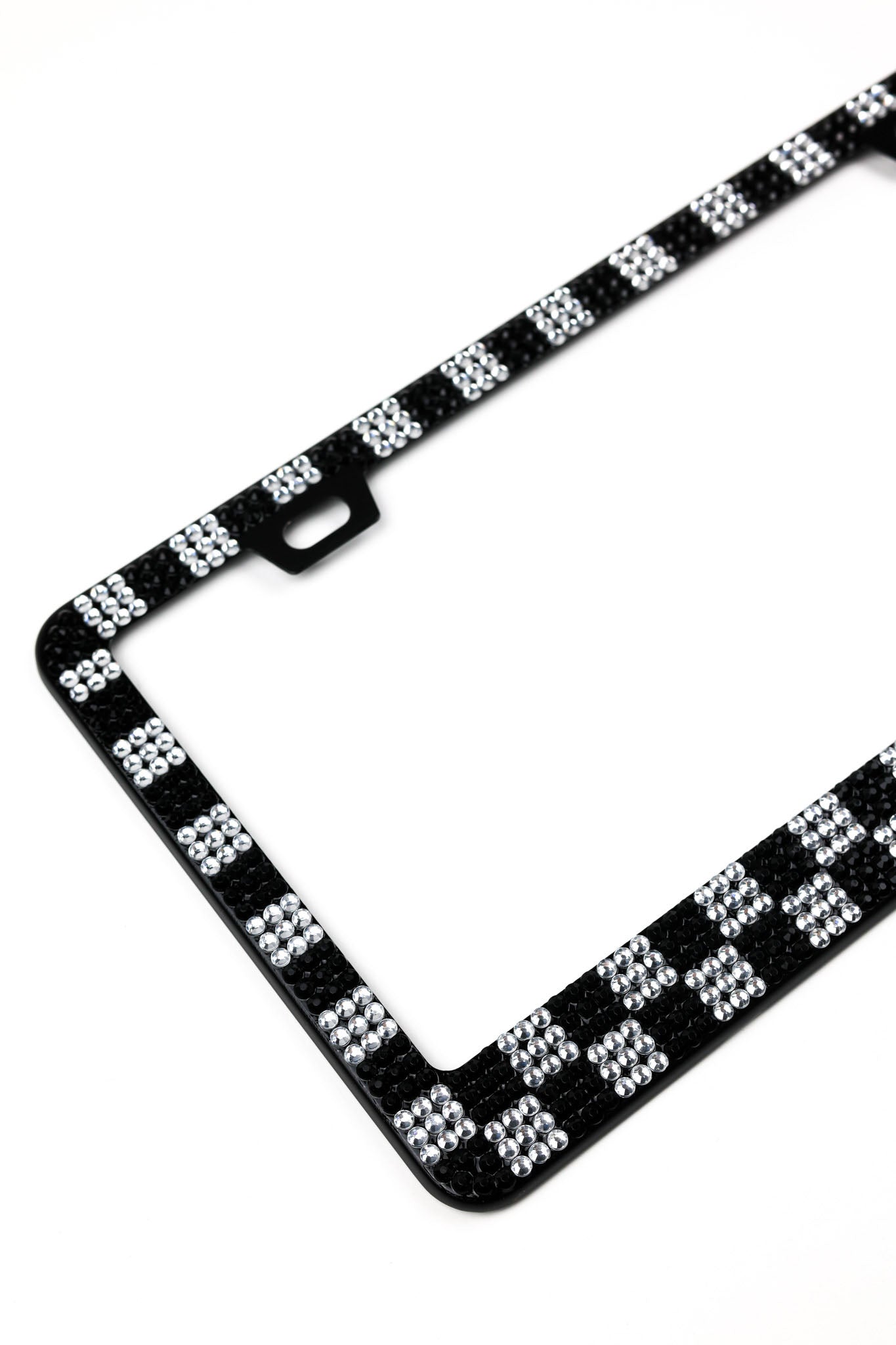 Checkered rhinestone license plate mounted on vehicle, front view