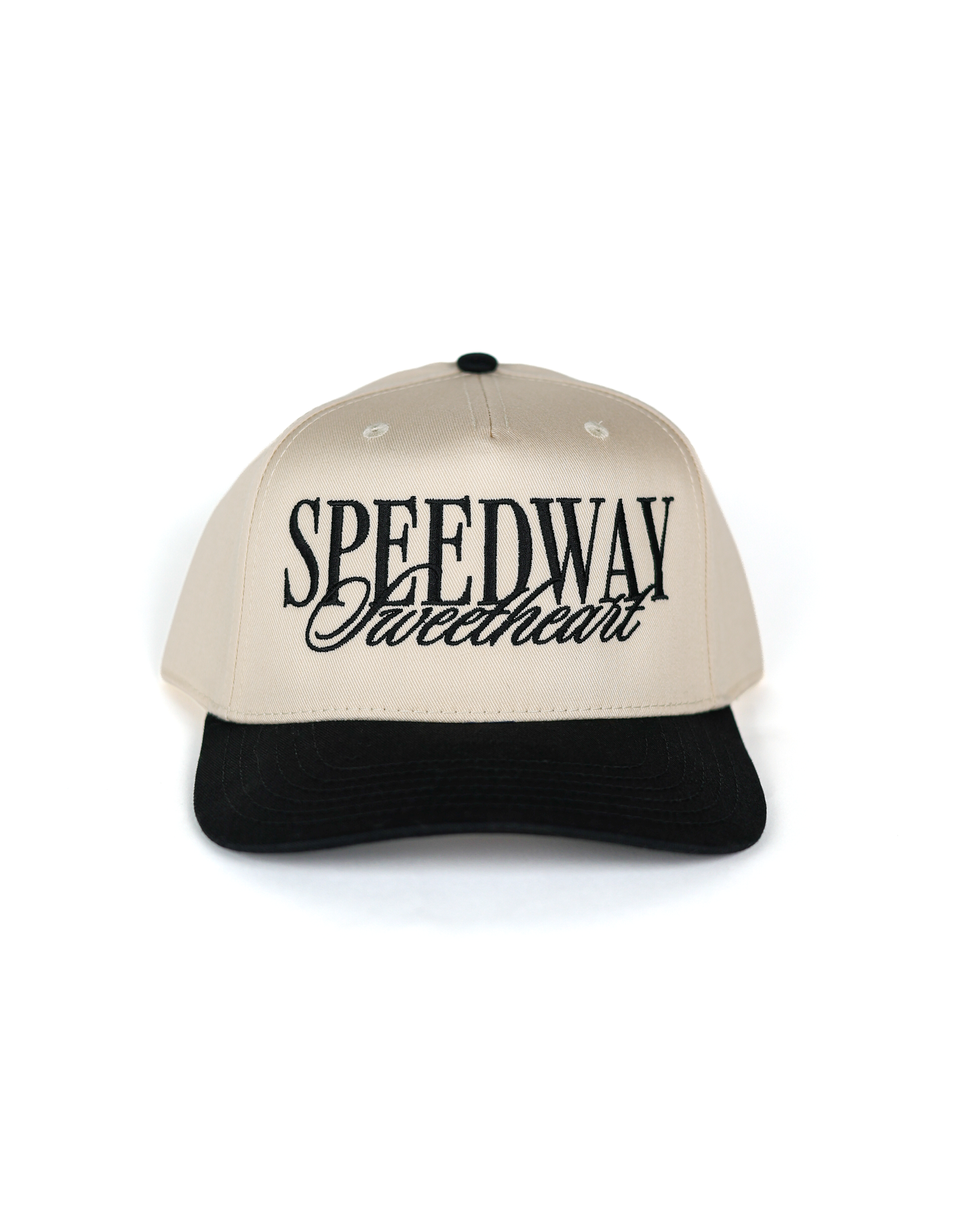 Shop the Speedway Sweetheart Hat by Race Royalty™ — a structured Otto 5-panel snapback in cream with a black brim and bold "Speedway Sweetheart" embroidery. Premium poly/cotton comfort for race day, on the go.
