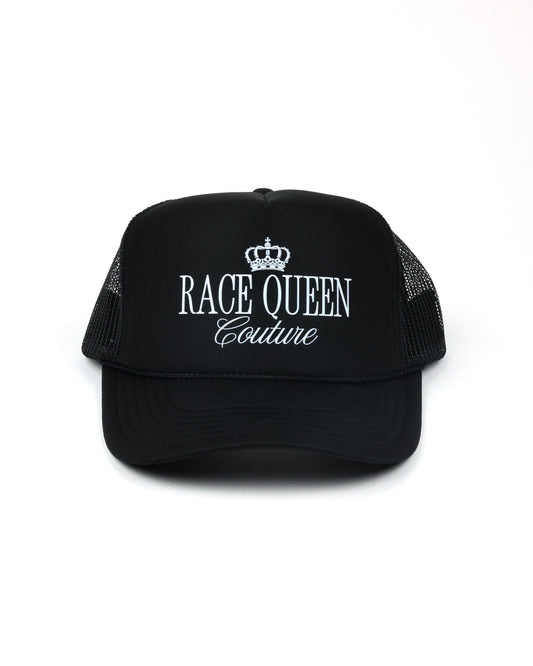 A black trucker hat with white embroidered text reading 'RACE QUEEN Couture' and a small crown graphic on the front, shown against a plain white background.