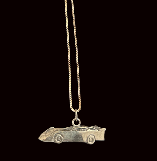 Necklace with a car-shaped pendant on a black background